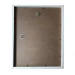 Backside of a wooden photo frame with a simple brown MDF backing, metal hangers, and a white border frame.