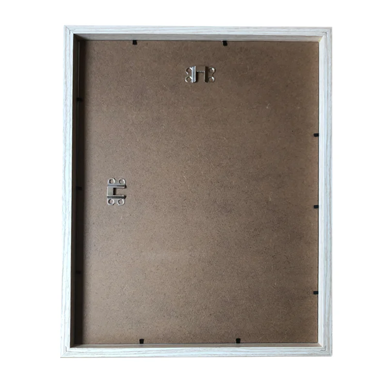 Backside of a wooden photo frame with a simple brown MDF backing, metal hangers, and a white border frame.