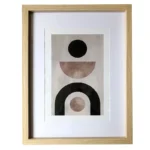 Minimalist abstract artwork featuring geometric shapes in an oak wood photo frame with a white matte border.