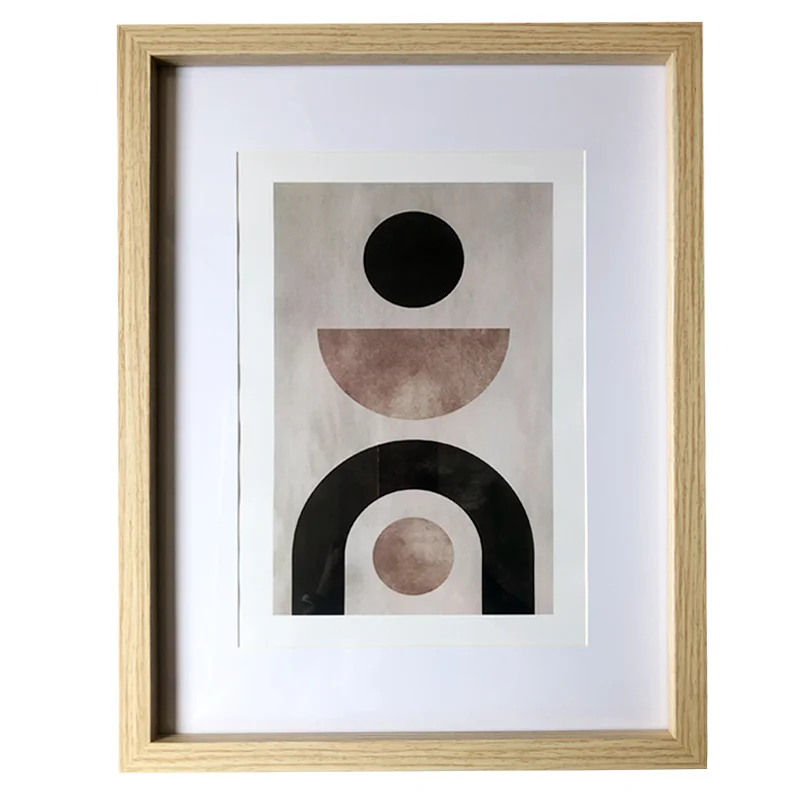 Minimalist abstract artwork featuring geometric shapes in an oak wood photo frame with a white matte border.