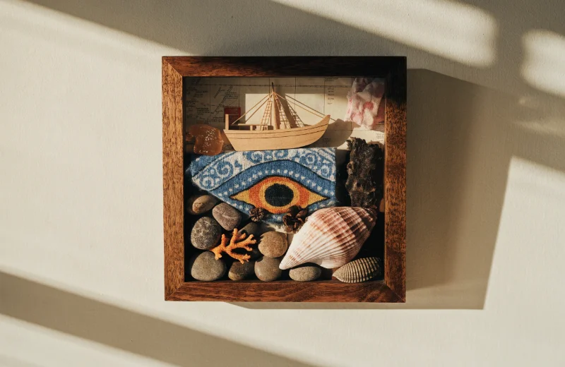 What a Shadow Box Frame is A beautifully arranged shadow box frame with travel souvenirs on a wall