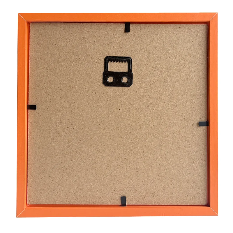 Back view of an orange photo frame with MDF backing, black corners, and a metal hanging hook for wall mounting.