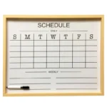 A wooden-framed white dry-erase board featuring a weekly schedule grid labeled Sunday to Saturday with space for daily and weekly notes. Includes an attached black marker.