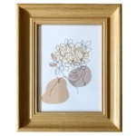 A wooden photo frame showcasing abstract line art of a face and flowers in soft neutral tones, perfect for home decor.
