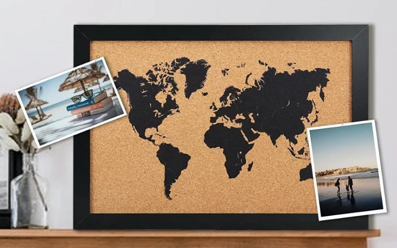 The Perfect Gift for Travelers A stylish push pin world map hanging in a living room, dotted with pins