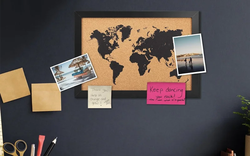 Telling a Story with a Pin Map A close-up of a world map with push pins holding small photos over specific countries