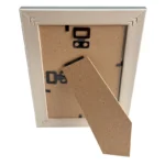 The backside of a photo frame showing an MDF stand, black wall-mount hooks, and an elegant corner design.
