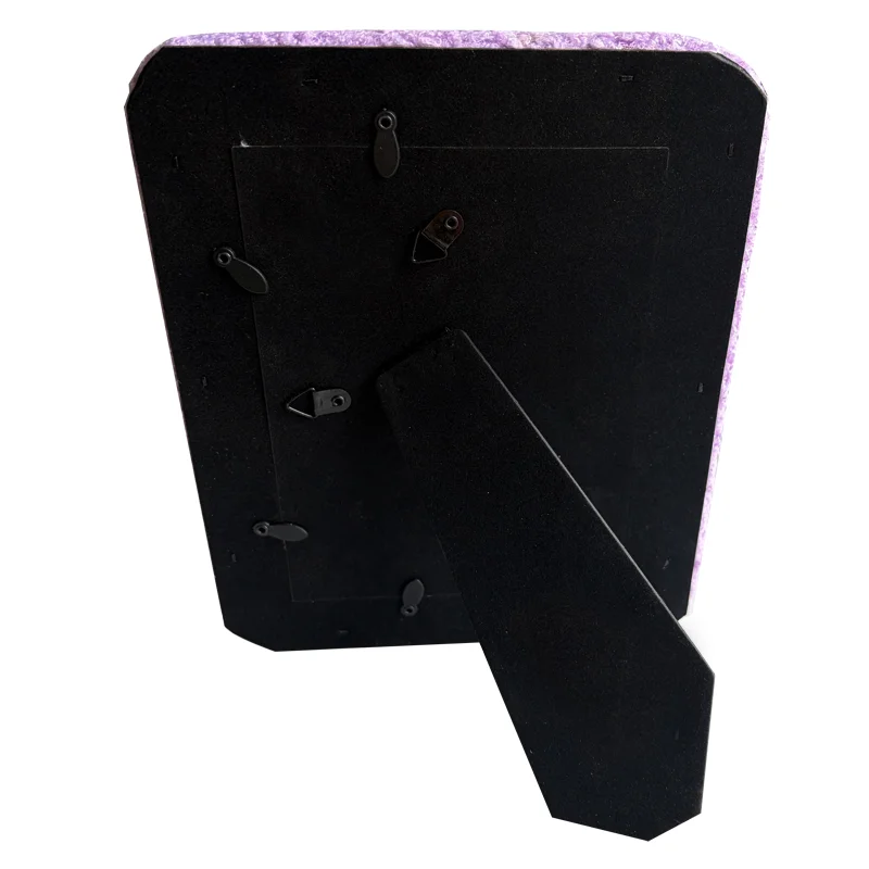 Black back panel of a photo frame featuring multiple mounting hooks and an adjustable stand.
