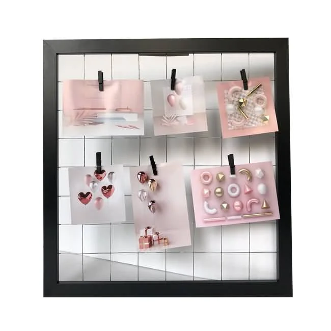 A black photo frame featuring a grid design holding six pastel cards with clips, showcasing decorative patterns and designs.