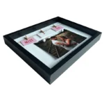 Black photo frame with a 'Miss You' design featuring mini clothespins holding decorative elements and a printed photo inside.