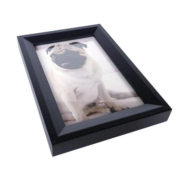 A black rectangular photo frame with a pug picture inside, placed on a white background.