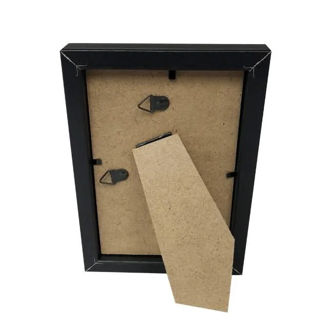 Back view of a black wooden photo frame showing a fold-out stand and hanging hooks on an MDF backing.