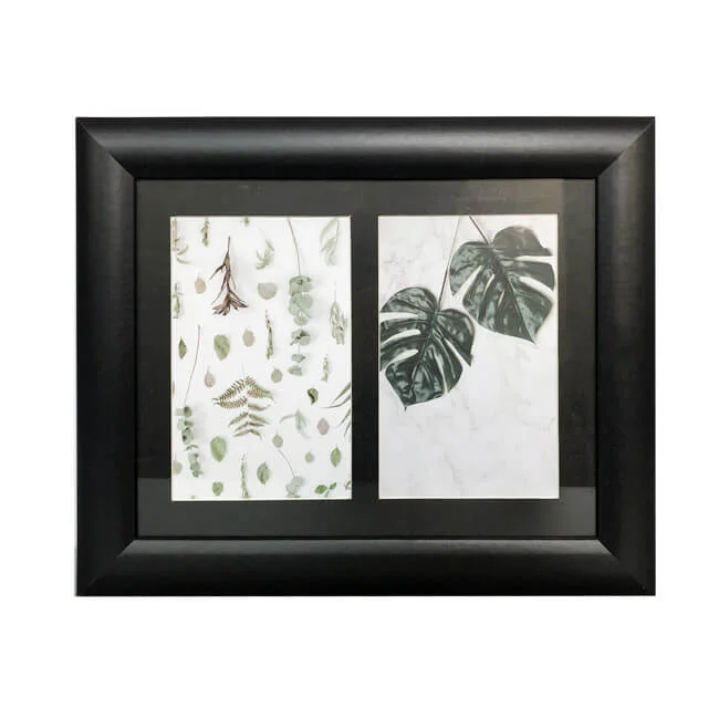 Black wooden photo frame featuring double slots with botanical prints of leaves and greenery on a white background.