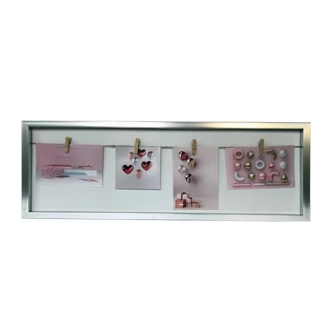 Collage photo display frame with a sleek silver border, containing pink-themed photos clipped on strings for wall decor.
