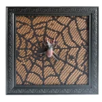 Ornate black frame with decorative lace background and a beetle ornament in the center for artistic home decor.