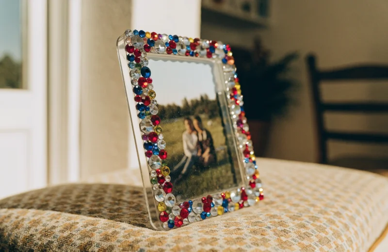 PS Frame with Rhinestone Decorations A decorative plastic photo frame with small, shiny rhinestones along the edge