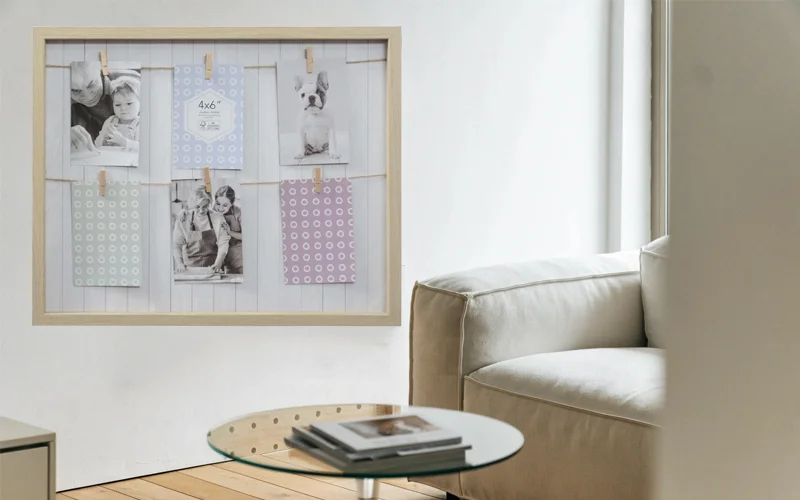 Peg Board Frame in Home Decor Setting A peg board frame in a natural wood finish hanging on a white wall in a modern living room.