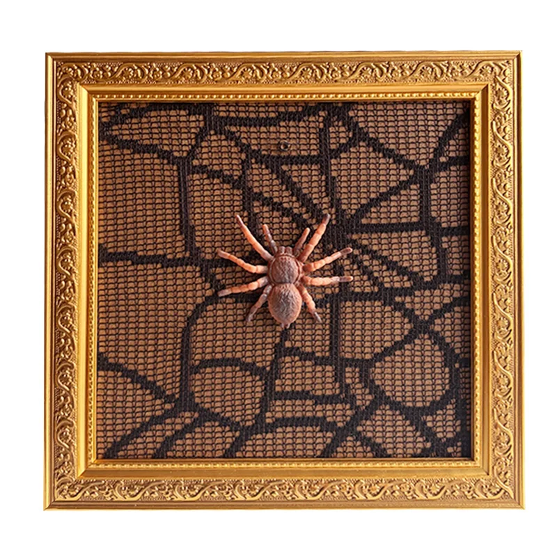 Ornate gold photo frame showcasing a textured spider-themed art design with a 3D spider figure on web-like mesh.