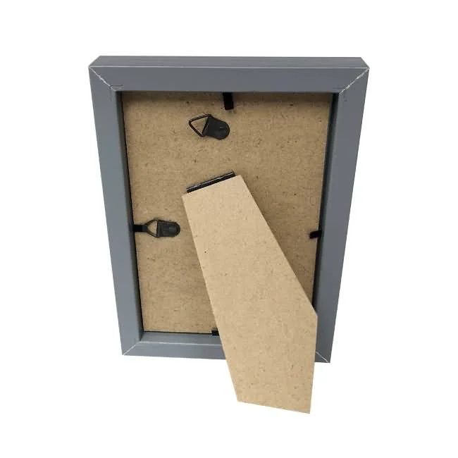 A gray MDF photo frame displayed from the back with dual hanging hooks and an adjustable stand for tabletop display.