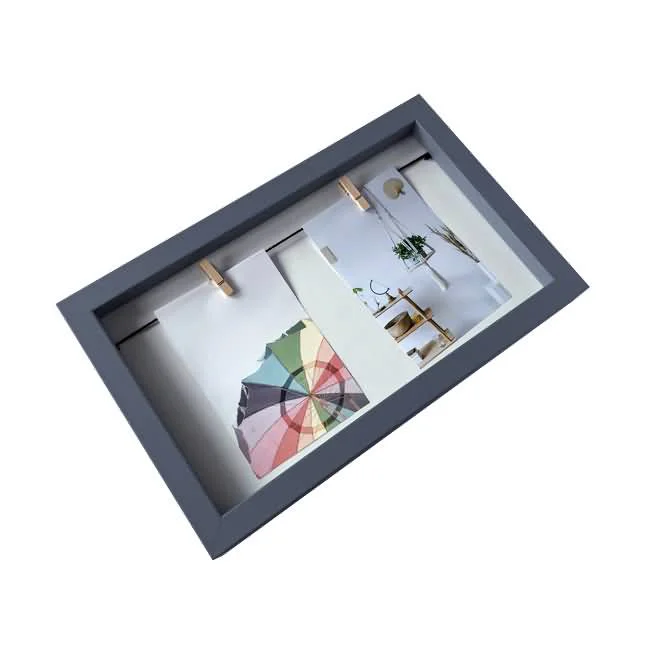 A gray wooden collage photo frame with two compartments, featuring colorful images and hanging clips inside.