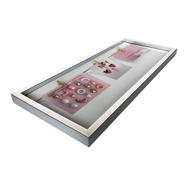 A sleek shadow box picture frame with multiple pink inserts, showcasing various jewelry pieces like earrings and pendants.