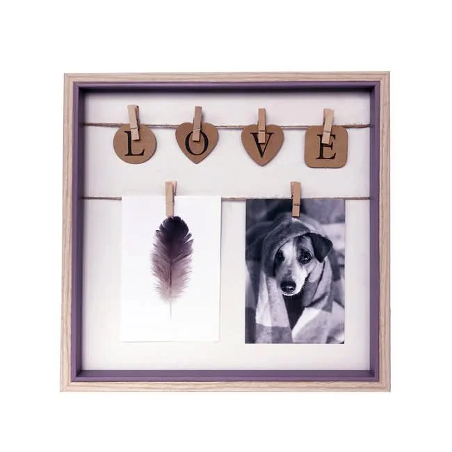 Square photo frame with LOVE letters on heart-shaped clips holding a feather photo and a dog photo.