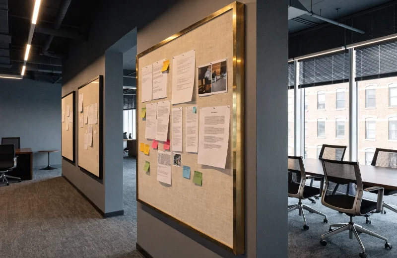 Framed Linen Bulletin Boards A collection of stylish framed linen bulletin boards in a modern office.