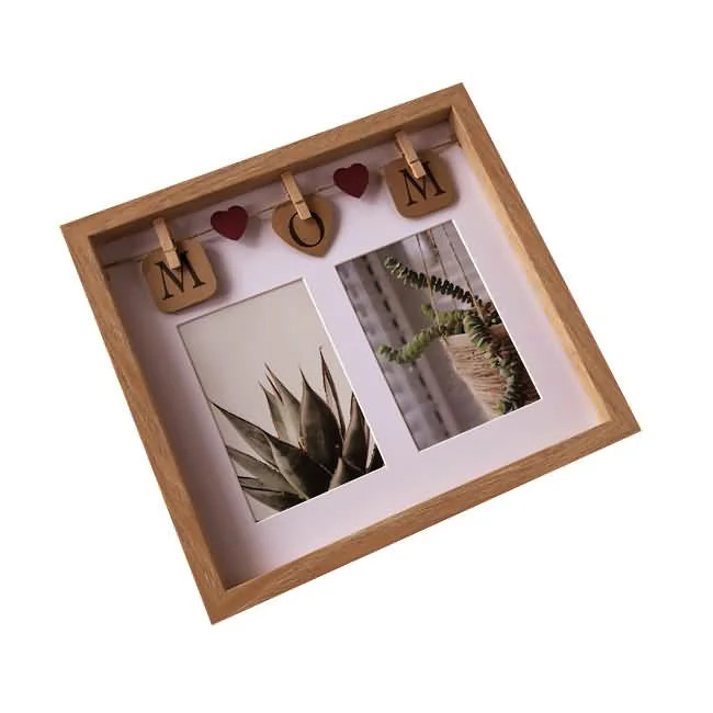 Square wooden photo frame with 'MOM' and heart decor hanging on clips, showcasing two plant-themed pictures underneath.