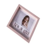 Pink shadow box frame displaying a young girl and the text 'It's a Girl,' designed for baby or kids themed decor.