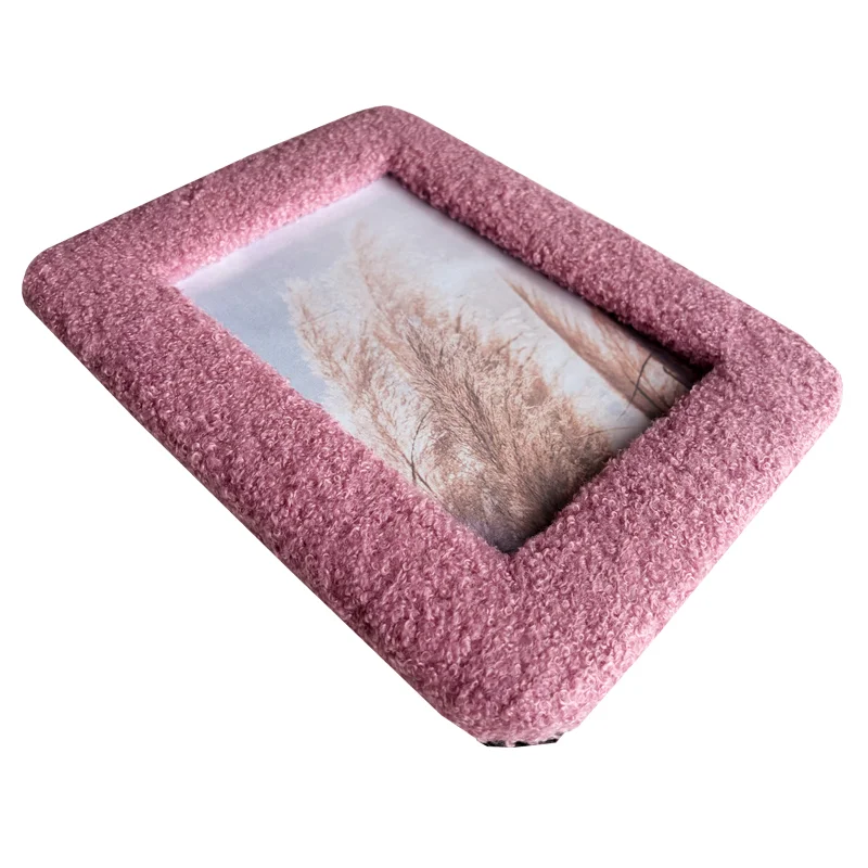 Pink textured photo frame with a soft exterior and a landscape image inside, angled for close-up detail.