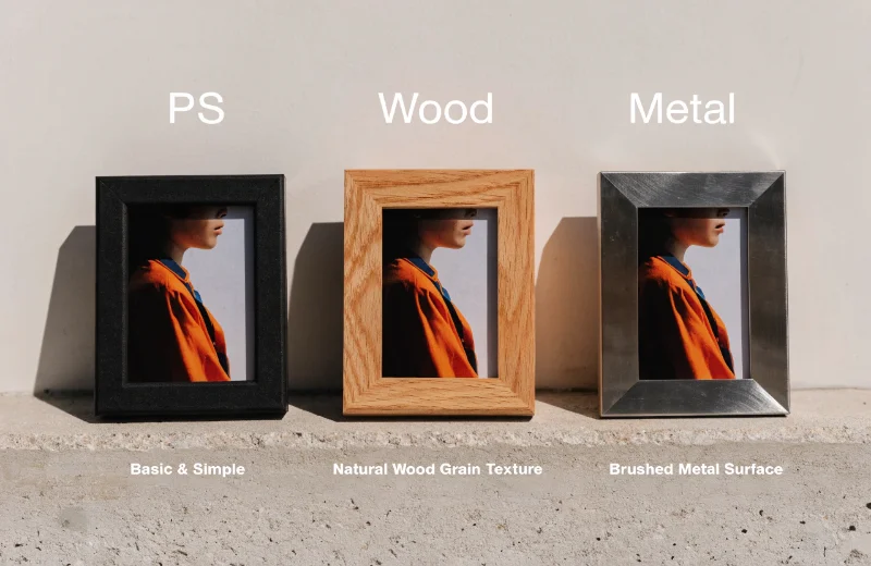 Comparison of Photo Frame Materials A simple, basic black PS photo frame next to frames made of wood and metal