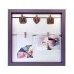 Purple square photo frame with decorative MOM design, equipped with small clips holding photos and a cozy aesthetic.