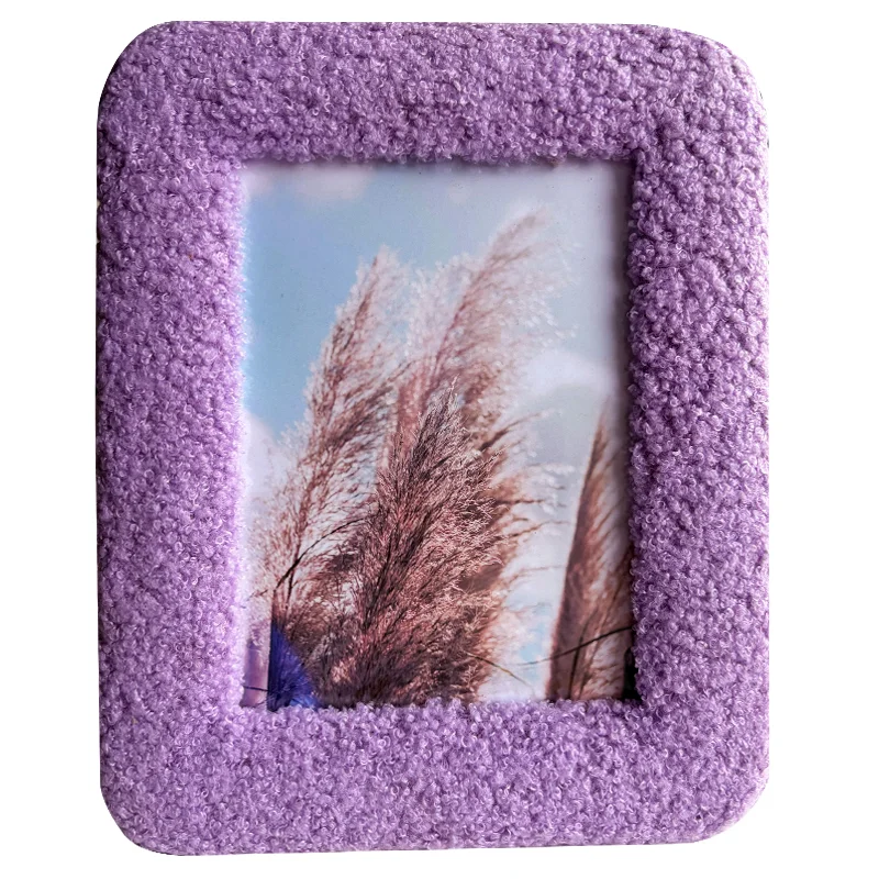 Purple textured photo frame with a soft, fluffy surface and an image of ornamental grass against a blue sky.