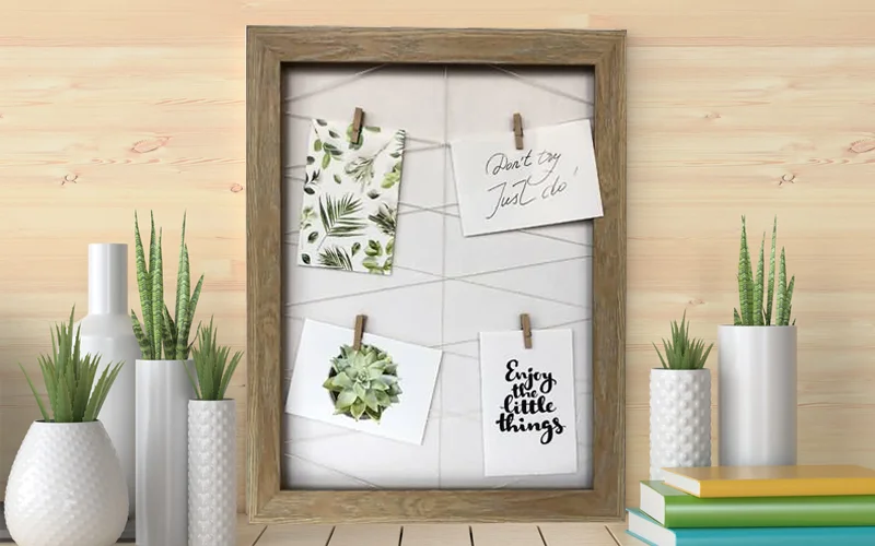Flexible Photo Display with Peg Board Frame A peg board frame displaying a mix of photo sizes, from large prints to small Polaroids.