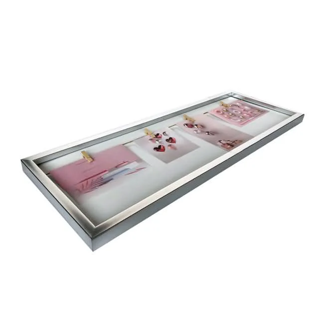 A silver collage photo frame featuring multiple photos clipped onto strings inside a rectangular frame for display.