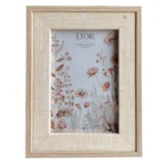 A wooden photo frame with light textured border featuring a floral print inside and a simple wood grain finish.