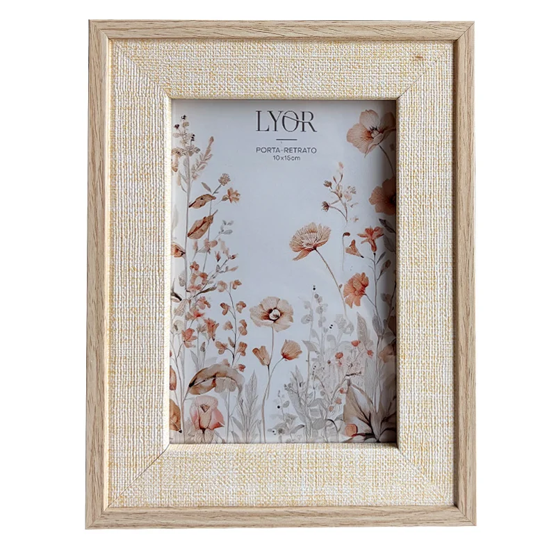A wooden photo frame with light textured border featuring a floral print inside and a simple wood grain finish.
