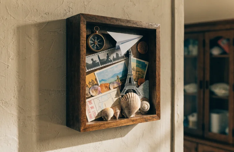 Deep Shadow Box Frame with 3D Objects A deep shadow box frame displaying travel souvenirs on a wall