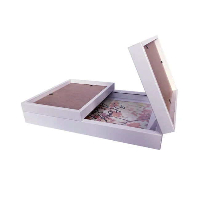 Stacked white MDF photo frames with backboards on display, showcasing versatile design and durability for pictures or artwork.