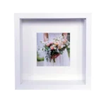 White shadow box frame displaying a wedding photo of a bride holding a colorful bouquet, ideal for home decor or keepsake display.