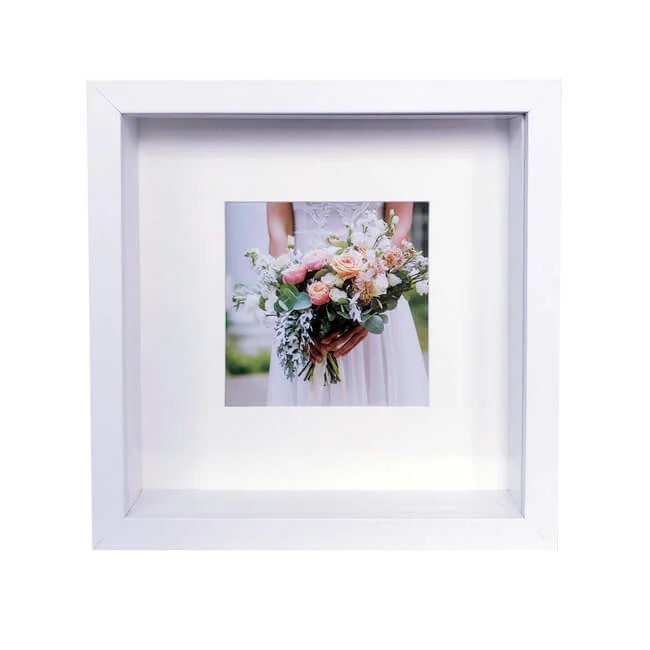 White shadow box frame displaying a wedding photo of a bride holding a colorful bouquet, ideal for home decor or keepsake display.