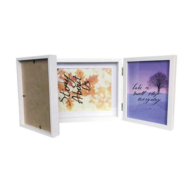 White tri-fold photo frame displaying inspirational prints with autumn leaves and winter tree design, one section empty.