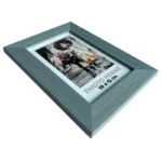 Gray photo frame with wood texture holding a 10x15 cm photo of a woman with flowers, displayed at an angle.