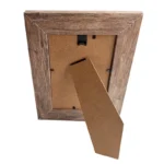A wooden photo frame with a rustic finish, showing its back side with an easel-style stand and wall-mounting hook.
