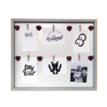 Wooden frame with six photo and card slots featuring heart-shaped accents, clip attachments, and a variety of prints.