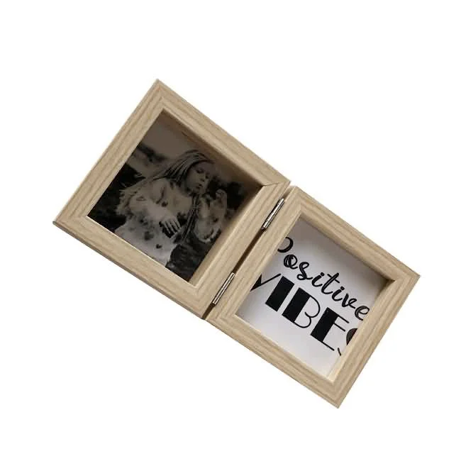 A wooden double photo frame featuring a black-and-white photo on one side and 'Positive Vibes' text on the other side, connected with a hinge.