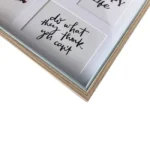 Close-up of a wooden photo frame featuring motivational quotes in elegant handwriting, highlighting inspiration and home decor.