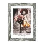Gray wooden photo frame displaying a sepia-toned portrait of a young girl in a floral dress holding a bouquet of roses.