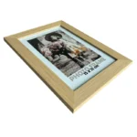 A wooden photo frame with a natural finish, showcasing a 15x21 cm picture of a girl holding flowers in a sepia tone.