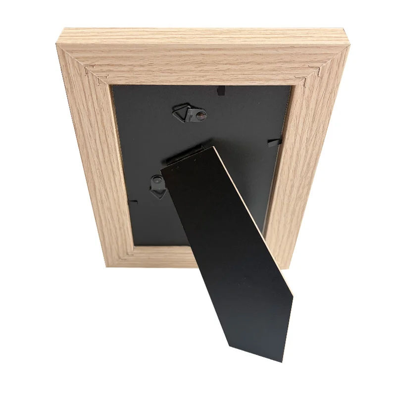 Back view of a wooden photo frame with a black stand and mounting hooks, showcasing sturdy design for desk or wall display.